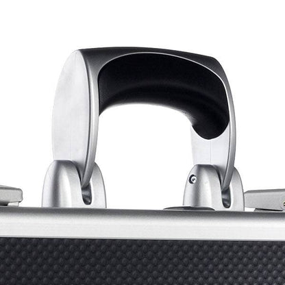 Close-up of the AZKE 95300 suitcase handle in silver and black, attached to a textured aluminum frame case featuring a scratch-resistant surface.