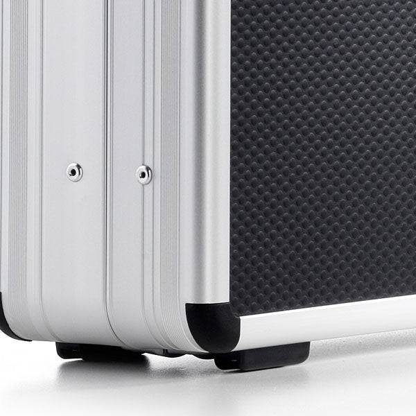Close-up of the AZKE 95600 case’s silver and black aluminum frame, featuring textured surfaces, metal edges, and protective corner caps.