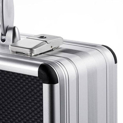 Close-up of the AZKE 95700: a silver aluminium frame case with a textured black panel, top-edge combination lock, and custom CNC foam fittings inside for added protection.