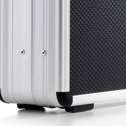 Close-up of the corner of the AZKE 95700 silver and black textured aluminium frame case featuring metal edges and protective plastic feet.