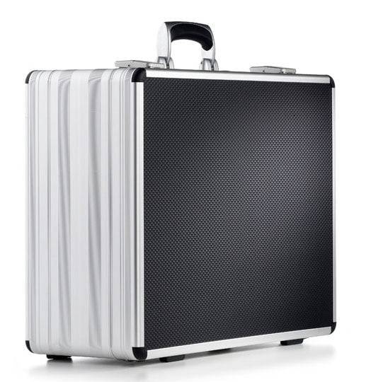 The AZKE 95700, a silver and black aluminium frame case with a textured front, sturdy handle, custom CNC foam fittings, and reinforced corners, is shown against a white background.