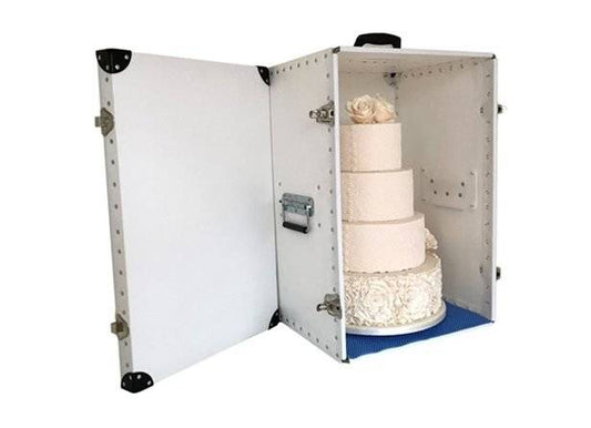 A white, four-tiered wedding cake with floral decorations is safely secured inside the Cake Transportation Case CTB2 for delivery.