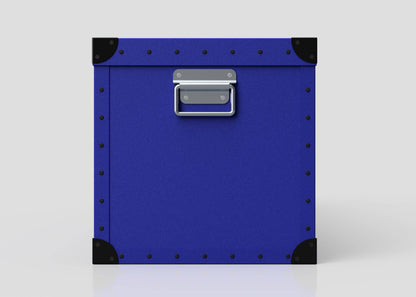 The Cricket Storage Poly Case (Large) is a square blue polyethylene box with black corner protectors, metal studs, and a zinc drop handle on the front, shown against a plain white background.