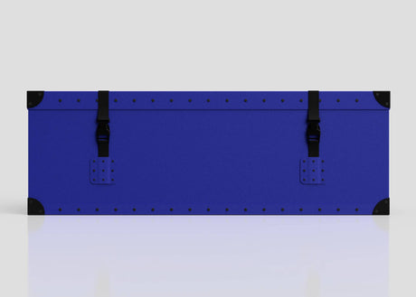 The Cricket Storage Poly Case (Small) is a blue rectangular polyethylene box with black corner protectors, two side-release buckle straps, and zinc drop handles, displayed against a plain light background.