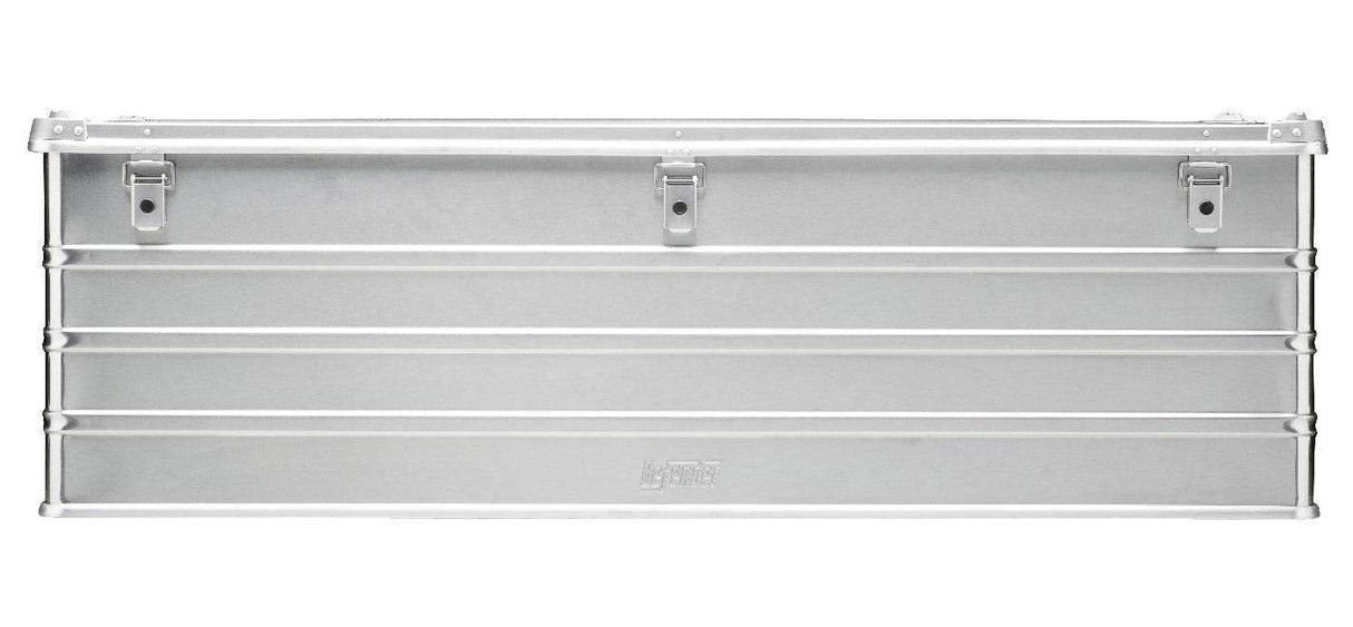 The Defender KA74-013 is a rectangular silver metal toolbox with horizontal ridges, three front latches, a flat hinged top, and a custom routed foam interior for secure tool storage.