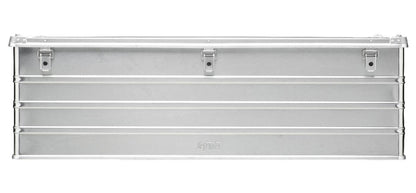 The Defender KA74-013 is a rectangular silver metal toolbox with horizontal ridges, three front latches, a flat hinged top, and a custom routed foam interior for secure tool storage.