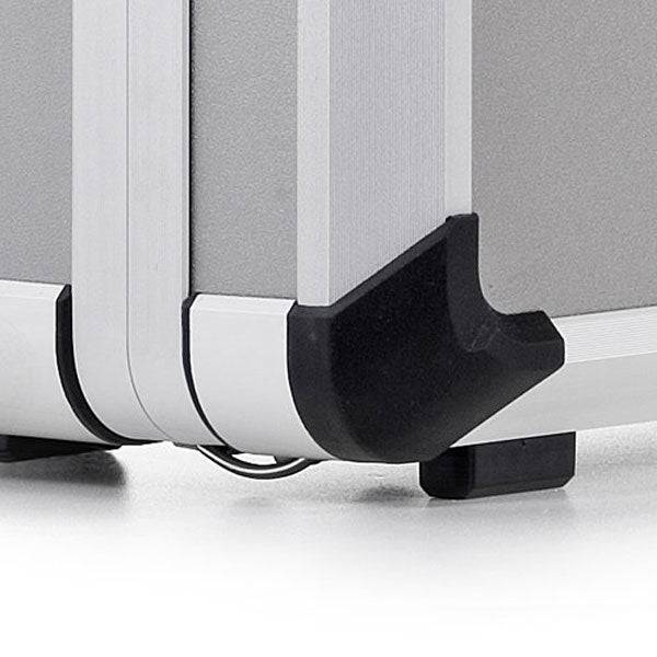 Close-up of the Exclusive 93400 aluminium frame case, featuring black plastic protective corner caps, resting on a light-colored surface.