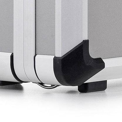 Close-up of the Exclusive 93700 aluminium frame case corner featuring a black protective plastic bumper and a small black foot on a flat surface.