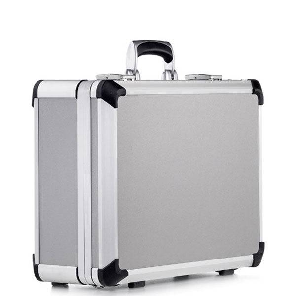 The Exclusive 93900 (460 x 340 x 174) is a closed silver aluminium briefcase with black reinforced corners and a sturdy black handle, designed for high carrying comfort and shown standing upright on a plain white background.