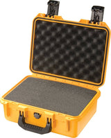 A yellow iM2100 Storm Case with a handle, shown open. Its interior features textured black foam for protection, making this crushproof case ideal for safely transporting valuable items.