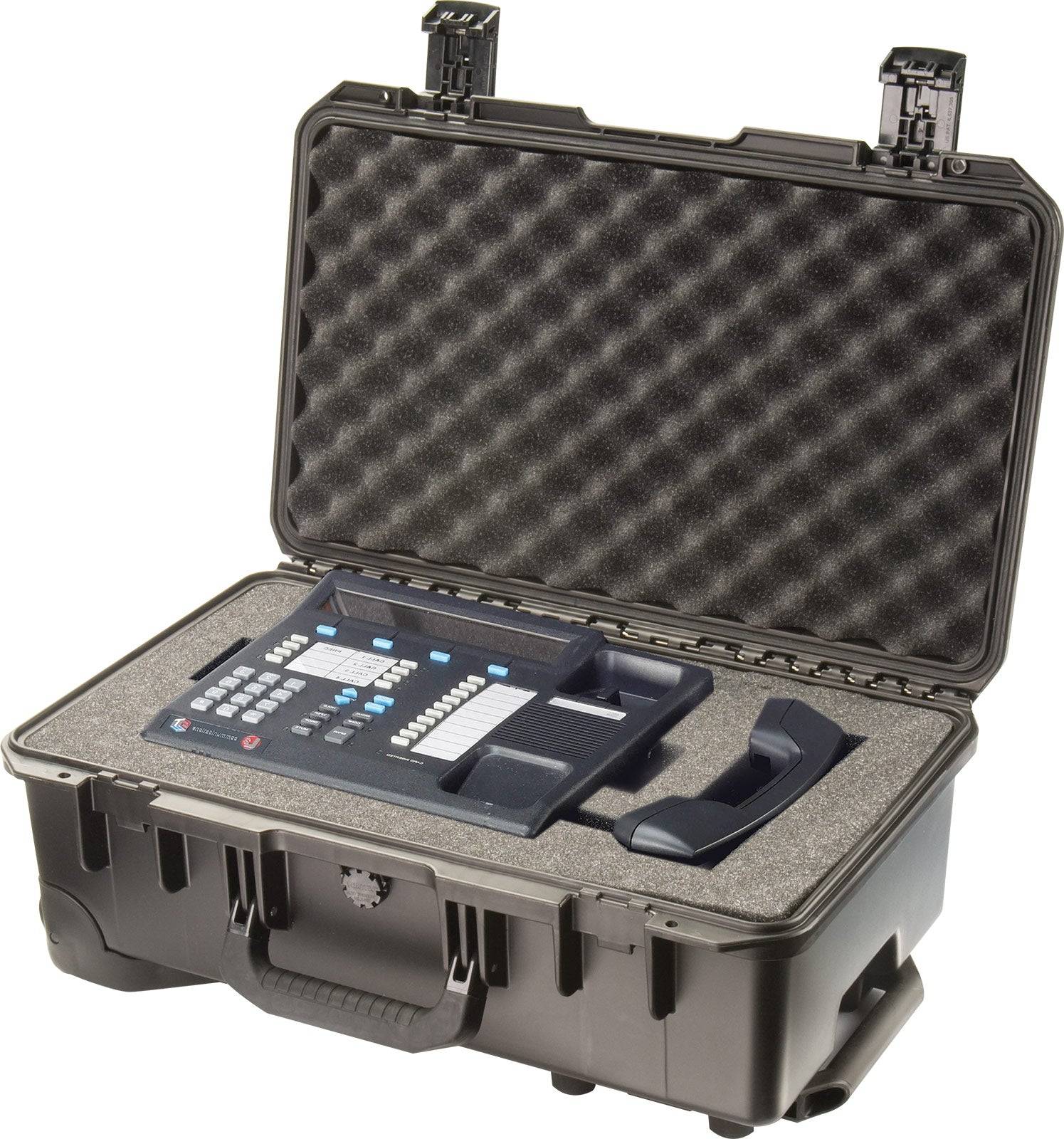 A black iM2500 Storm Carry-On Case with foam padding holds a keypad control device and a wired handset, each secured in custom-cut compartments for maximum protection.