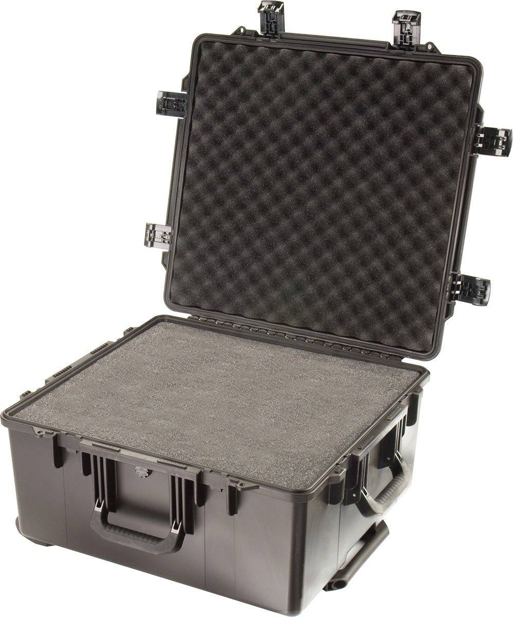 A large black iM2875 Storm Travel Case with custom CNC foam inside, open lid, multiple Press and Pull latches visible, and a sturdy carrying handle.