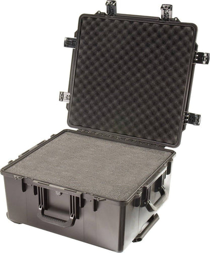 A large black iM2875 Storm Travel Case with custom CNC foam inside, open lid, multiple Press and Pull latches visible, and a sturdy carrying handle.