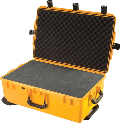 An open yellow iM2950 Storm Travel Case reveals custom CNC foam fittings in the lid and base, with black latches and a handle visible for secure protection.