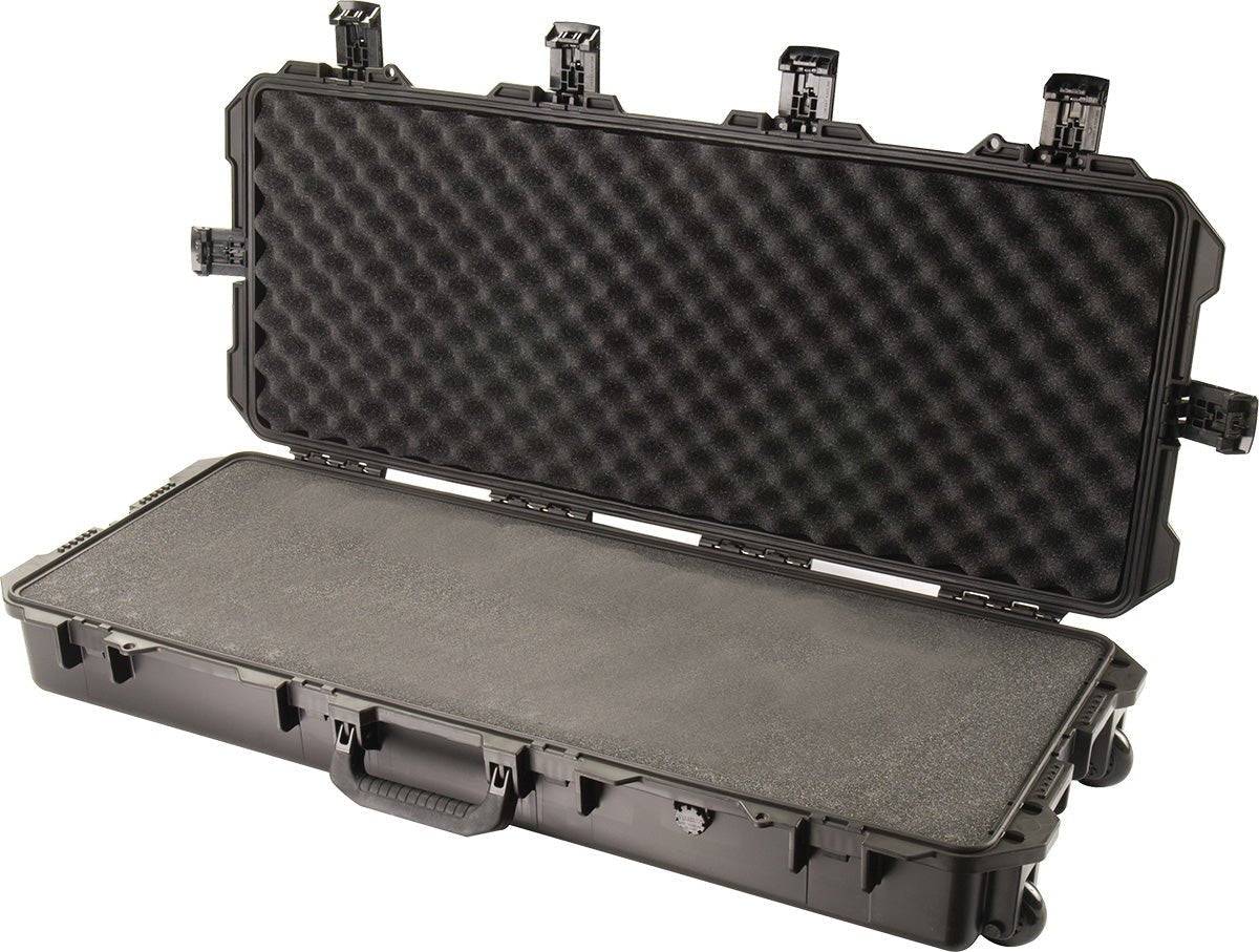 An iM3100 Storm Long Case is open, displaying custom CNC foam inside. The black hard-shell case includes multiple Press and Pull latches and a sturdy front handle for secure transport.