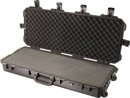 An iM3100 Storm Long Case is open, displaying custom CNC foam inside. The black hard-shell case includes multiple Press and Pull latches and a sturdy front handle for secure transport.
