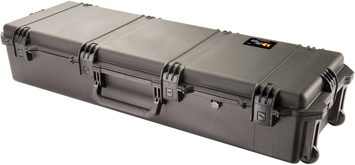 The iM3220 Storm Long Case is a large, rectangular black PELI case with a handle, wheels, and Press and Pull latches, ideal for secure equipment transport and available with optional custom CNC foam fittings.