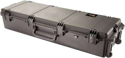 The iM3220 Storm Long Case is a large, rectangular black PELI case with a handle, wheels, and Press and Pull latches, ideal for secure equipment transport and available with optional custom CNC foam fittings.