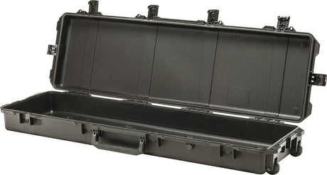 The open iM3300 Storm Long Case, a large black PELI case made of HPX Resin, features an empty interior, handle, wheels, and secure Press and Pull latches.