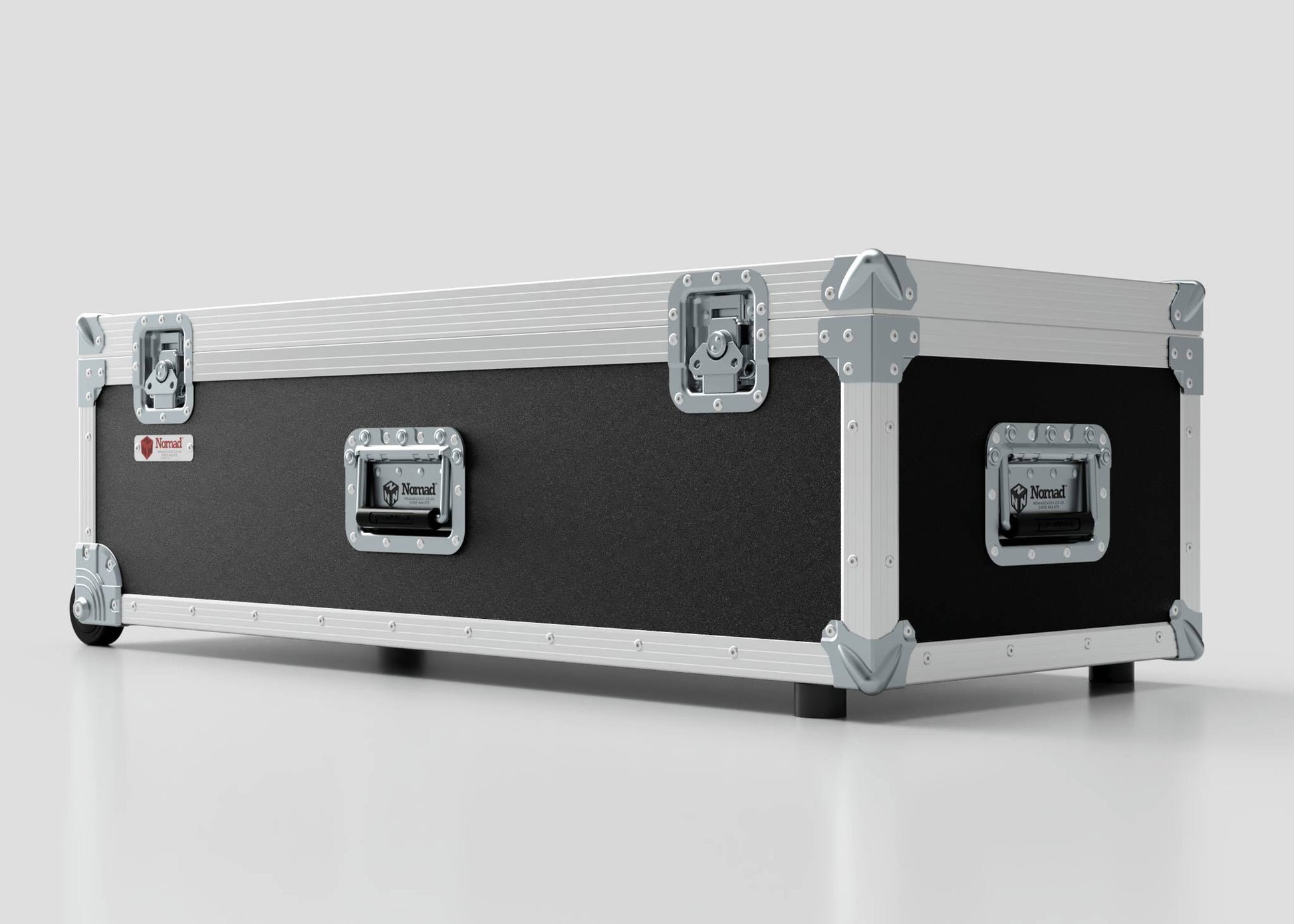 The Lid Maker Trunk Case is a large, black and silver hard case with metal reinforcements and latches, measuring 1010 x 400 x 410 mm, shown on a white surface.