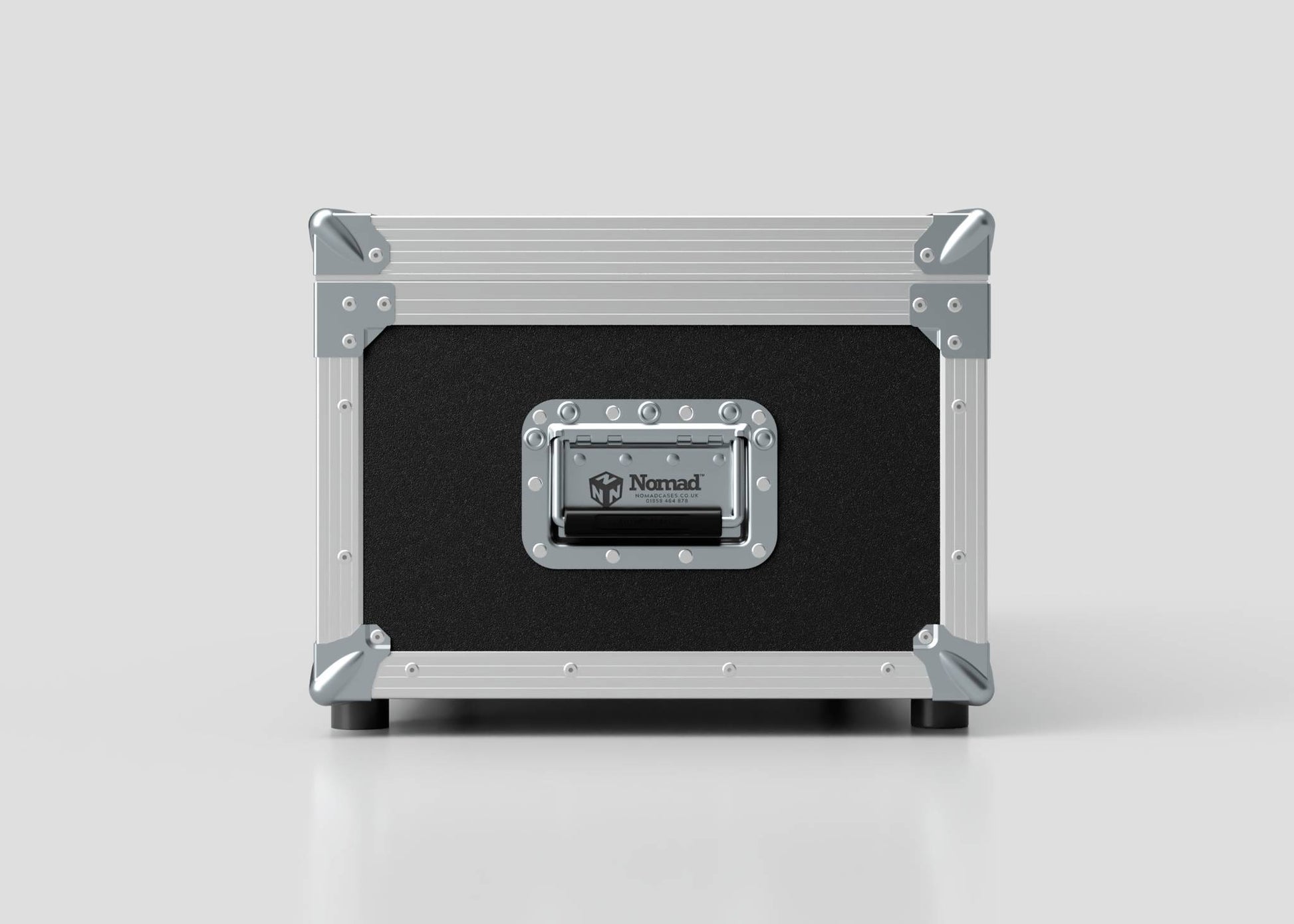 A black and silver Lid Maker Trunk Case with metal corners, a handle, and a Nomad label on the front sits on a plain white surface. Its external dimensions are 1010 x 400 x 410 mm.