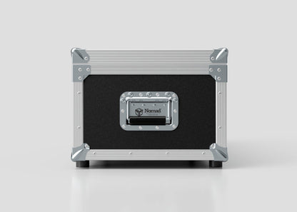 A black and silver Lid Maker Trunk Case with metal corners, a handle, and a Nomad label on the front sits on a plain white surface. Its external dimensions are 1010 x 400 x 410 mm.