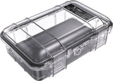 The M50 PELI Micro™ Case is a transparent waterproof case with a black base, secure latch, and lid label, offering IP67 protection for small valuables or electronics.
