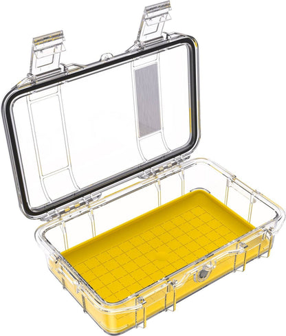 The open M50 PELI Micro™ Case, made of transparent, hard plastic with a yellow base and grid pattern, is shown empty with two hinged latches visible.