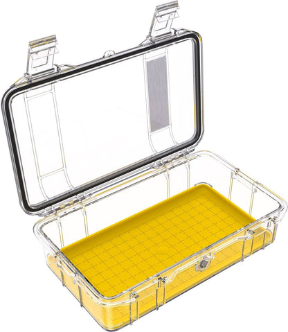 The M60 PELI Micro™ Case is a clear IP67 waterproof protective case with a hinged lid and yellow grid-patterned base, shown open and empty.