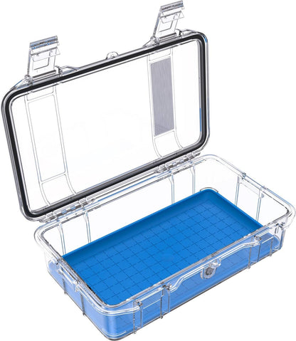 An open M60 PELI Micro™ Case with a hinged lid reveals its blue, grid-patterned base inside. The case is transparent and crushproof.