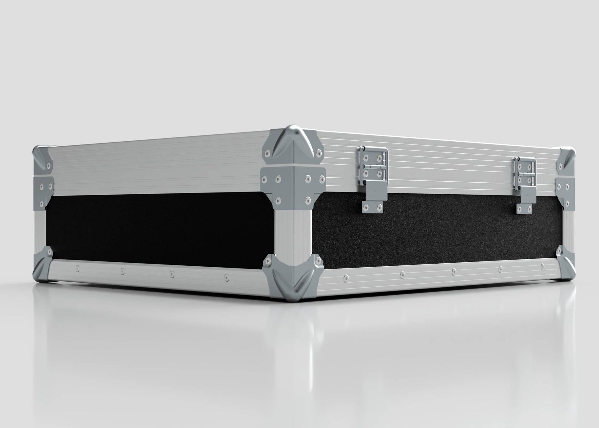 The Microphone Case is a rectangular, silver and black hard case with reinforced metal corners and two metal latches, measuring 577 x 526 x 192 mm, shown resting on a reflective white surface.