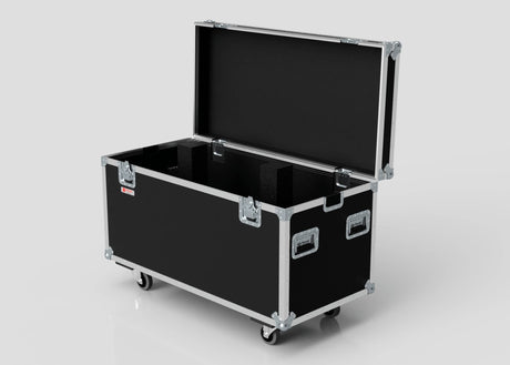 The Multicore Trunk Case, a large black road case with metal edges, handles, foam-lined interior, and four caster wheels, is open and set against a plain background.