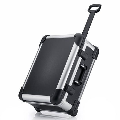 The Robust 50200N (555 x 425 x 235) is a black and silver hard-shell rolling suitcase with custom foam fittings, telescopic and side handles, standing securely on two wheels.