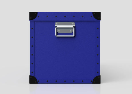 The Rugby Storage Poly Case (Large) is a square, blue durable case with black corner protectors, metal rivets on the edges, and a centered silver handle—perfect for rugby gear—shown against a plain white background.