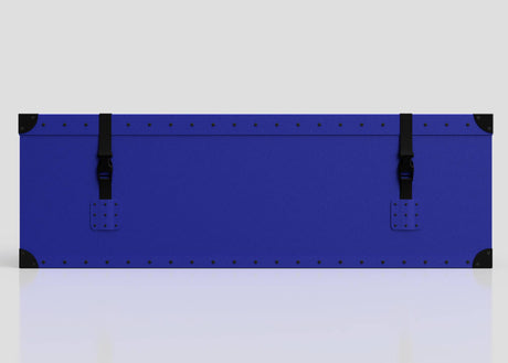 The Rugby Storage Poly Case (Medium)—a rectangular blue polyethylene box with black corner protectors and two side-release buckle straps—is displayed against a plain light background.