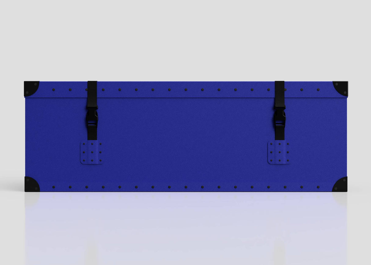 The Rugby Storage Poly Case (Small) is a blue, rectangular polyethylene box with black corner protectors, two black front buckle straps, and a sturdy zinc drop handle, shown against a plain light background.