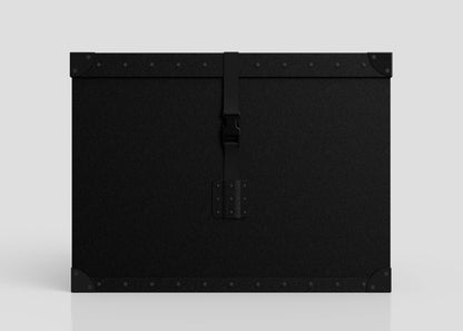The Standard Cube Storage Box - Large is a rectangular black case with reinforced corners, metal rivets, and a central webbing buckle strap, shown against a plain light background.
