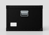 The Standard Cube Storage Box - Medium is black polyethylene with a metal handle, corner protectors, and a blank white label on the lower left corner.