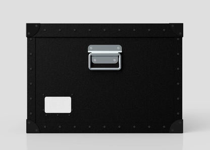 The Standard Cube Storage Box - Medium is black polyethylene with a metal handle, corner protectors, and a blank white label on the lower left corner.