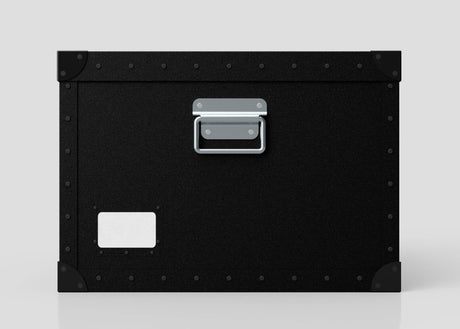 The Standard Cube Storage Box - Medium is black polyethylene with a metal handle, corner protectors, and a blank white label on the lower left corner.