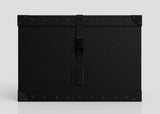 The Standard Cube Storage Box - Medium is a black, rectangular polyethylene box with reinforced corners, metal rivets on the edges, and a central front latch.