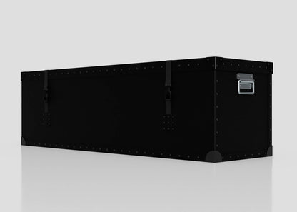 The Standard Long Storage Box - Large is a black, rectangular trunk with metal rivets, corner protectors, two front latches, and a zinc drop handle, shown on a plain white surface.