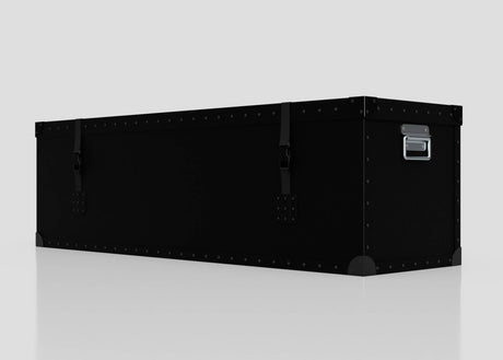 The Standard Long Storage Box - Large is a black, rectangular trunk with metal rivets, corner protectors, two front latches, and a zinc drop handle, shown on a plain white surface.