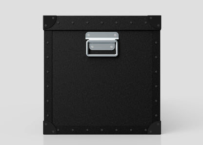 The Standard Long Storage Box - Large is shown in black metal and polyethylene with corner reinforcements and a zinc drop handle, set against a plain light gray background.