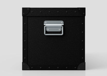 The Standard Long Storage Box - Medium is a black, square polyethylene box featuring riveted metal corners and a zinc drop handle on the front, shown against a light gray background.