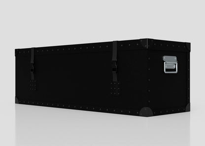 A Standard Long Storage Box - Medium, rectangular and black with metal rivets, corner protectors, two latches, and a zinc drop handle sits on a reflective surface against a plain background.