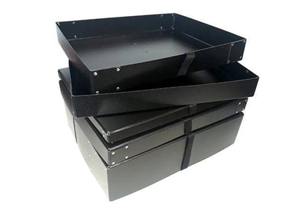 A stack of Standard Photographic Print Box 4" black metal trays with raised edges, perfect for organizing prints, is placed one atop another on a white background.