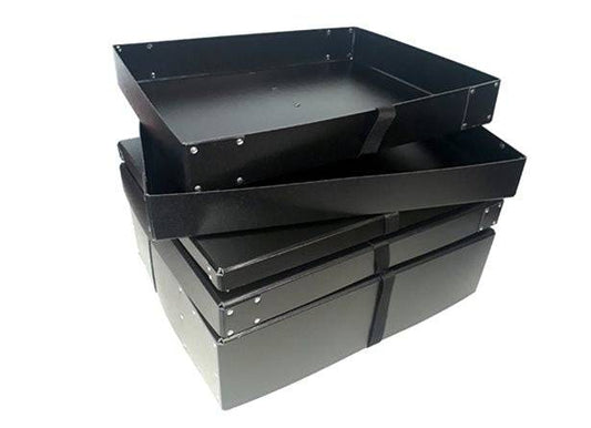 A stack of Standard Photographic Print Box 4" black metal trays with raised edges, perfect for organizing prints, is placed one atop another on a white background.