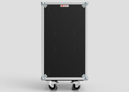 The TM TV Drawer Case is a large black road case with metal edges, corner protectors, and side attachment features, standing upright on four caster wheels—perfect for storing items like a trestle table, against a plain light background.