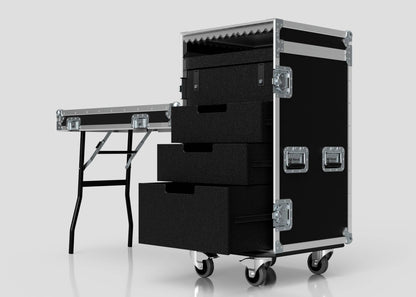 The TM Whiteboard Drawer Case, a black rolling equipment case with metal edges and external dimensions for easy transport, is open to show three foam-lined drawers and is placed beside a trestle table on a white background.
